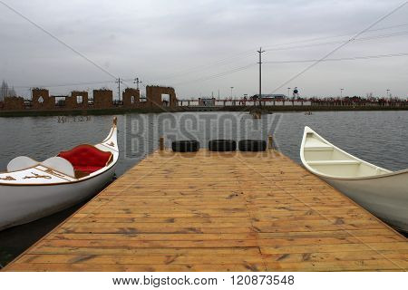 Shore of the lake, two white boat ready to set sail.
