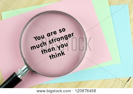 Magnifying glass on papers with inspirational words