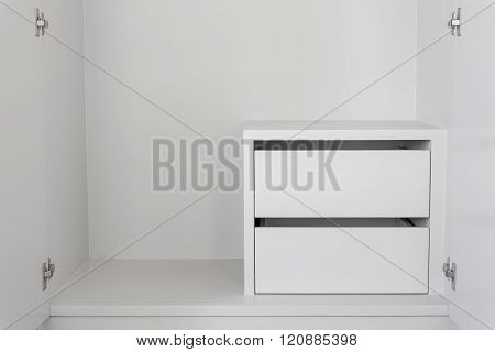 White Drawer in empty cupboard with free copy space.