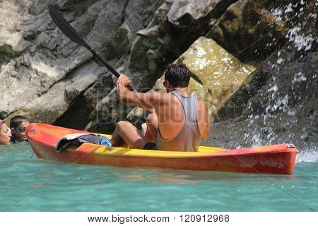 Young Man Kayaking In The River