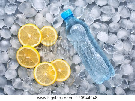 Plastic Bottle Of Water With Slice Of Lemon In Ice