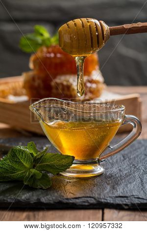 Honey Dripping From A Wooden Honey Dipper