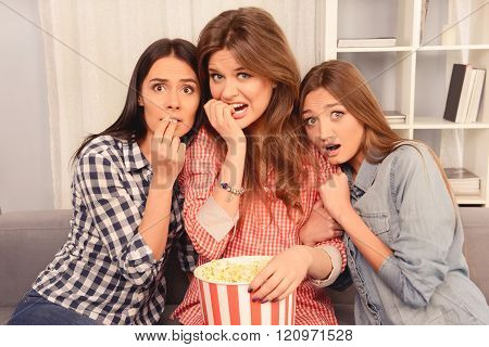 Close Up Photo Of Afraid Girls Wathing Movie And Eating Popcorn