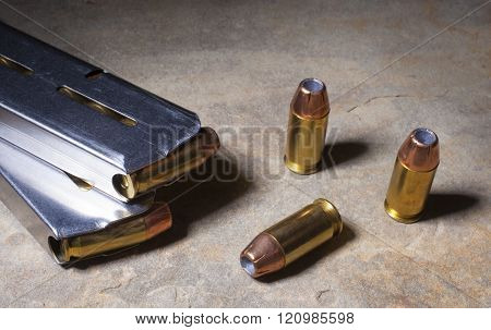 Cartridges with hollow point bullets and magazines for semi auto pistol