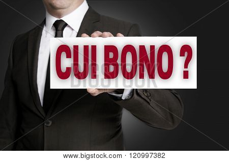 Cui Bono Sign Is Held By Businessman Background