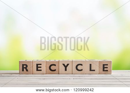 Recycle Sign On A Wooden Table