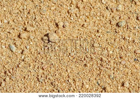 The texture of yellow coarse sand in a career