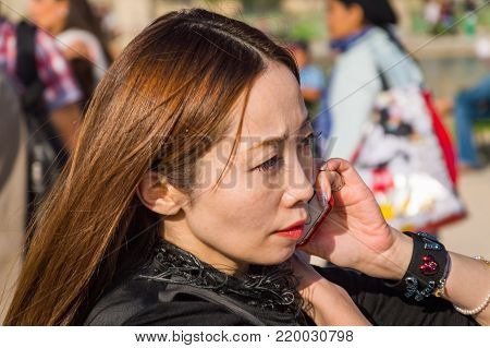 Stylish european woman in the Tuileries Garden. Paris Fashion Week: Ready to Wear 2014-2015 is held from September 25 to October 1, 2014. France, Paris, September, 25, 2014