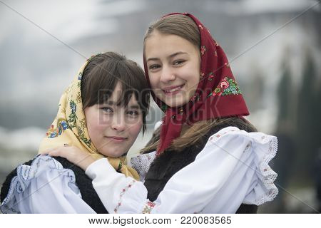 Barsana, Maramuresh/Romania - 12.25.2017: Two girls dressed in traditional Romanian clothes (Maramuresh region).