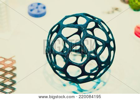 Abstract object of a blue color printed on a 3d printer on a white table. Fused deposition modeling, FDM. Progressive modern additive technology. Concept of 4.0 industrial revolution