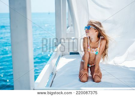 Little girl spend time on the beach bed