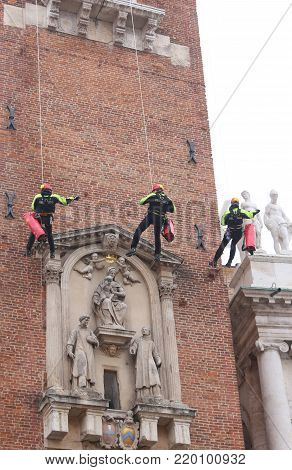 Vicenza, Italy - December 4, 2015:  Firefighter Unroll Italian Flag On The Ancient Tower Called Torr