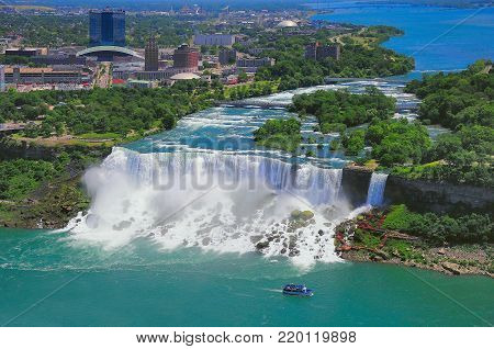 Niagara Falls from the US side, Bride Veil Falls. Boat with tourists moves along Bride Veil Falls.