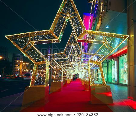 MOSCOW, RUSSIA - DECEMBER  2017:  New Year 2018 and Christmas  New Year's decoration of a street in the form of a tunnel of stars in Moscow