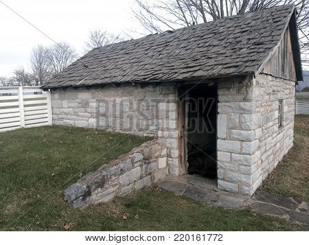 Civil War era stone icehouse with weathered, handmade wooden shake shingle roof
