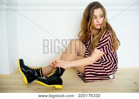 A portrait of a teen girl model in a stdio