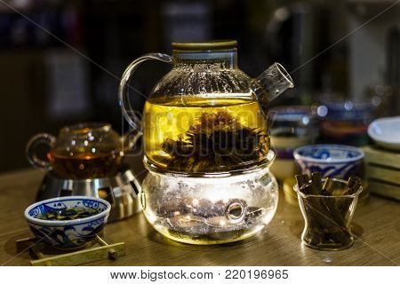Blooming Flower Tea in Glass Tea Pot with traditional chinese accessories. teashop