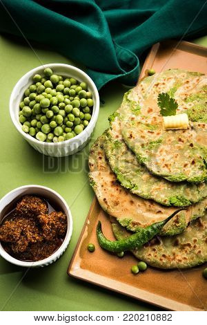 Green peas stuffed paratha or matar ka paratha, which is a traditional and popular food native to north India, made from dough of wheat flour and green peas or matar, served with mango pickle, curd bundi etc