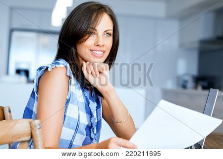 Woman with papers in their living room
