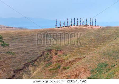 Wooden Ritual Pillars With Colorful Ribbons Hadak On Cape Burkhan. Lake Baikal. Olkhon Island. Russi
