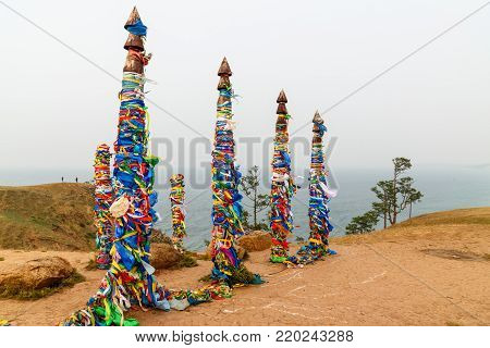 Wooden Ritual Pillars With Colorful Ribbons Hadak On Cape Burkhan. Lake Baikal. Olkhon Island. Russi