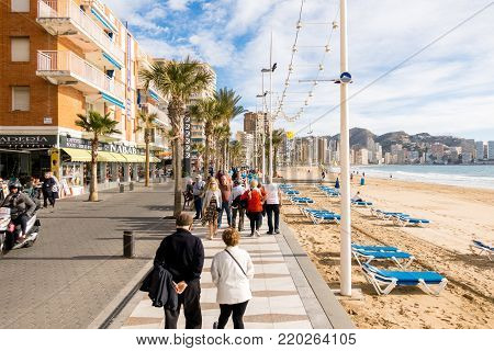 BENIDORM, SPAIN, December 14, 2017: People walking on the embankment of Benidorm, Spain