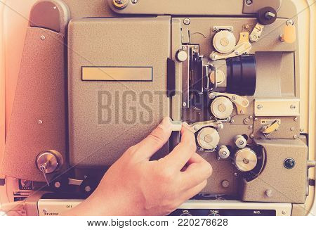 Close Up Of Vintage Classic Mobile 8Mm Or 16Mm Movie Film Projector With Hand And Vintage Color Styl