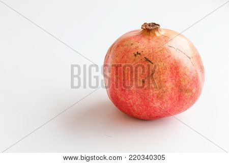 Red ripe pomegranate isolated on a white background.