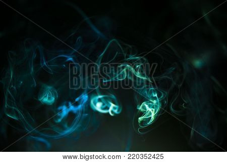 colorful smoke on dark background with liht