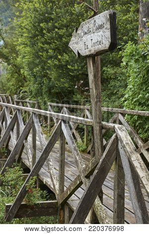 Tortel, Patagonia, Chile - November 16, 2017: Wooden walkway in the coastal village of Tortel built into the steep hillsides of northern Patagonia in Chile.