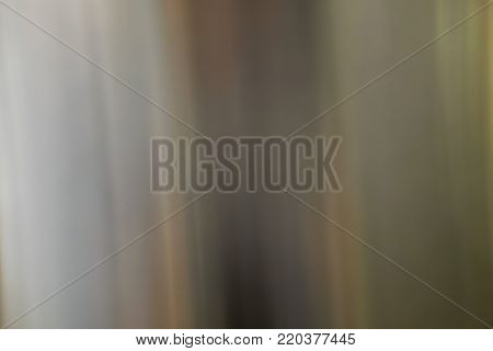 Shiny stainless steel in golden tones with soft vertical lines.