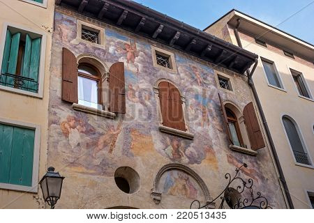 An ancient fresco on the facade of the house. Conegliano. Italy.