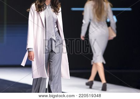 Sofia, Bulgaria - 28 September, 2017: Two female models walk the runway in different dresses during a Fashion Show. Fashion catwalk event showing new collection of clothes.