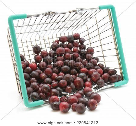 Cranberries out a shopping basket isolated on white background