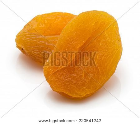 Two whole dried apricots isolated on white background
