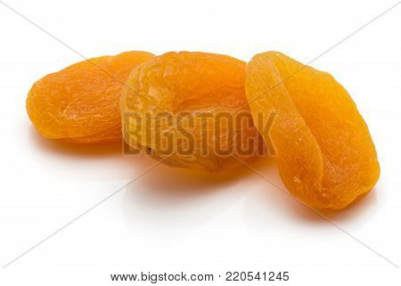 Three whole dried apricots isolated on white background