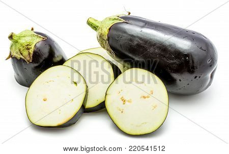 One whole and sliced eggplant (aubergine), cut in round circles, isolated on white background