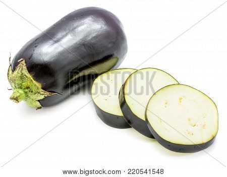 One whole and sliced eggplant (aubergine), round slices, isolated on white background