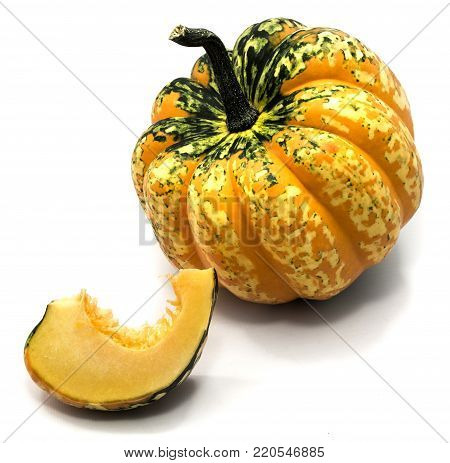 One cut spotted green yellow pumpkin and one slice isolated on white background