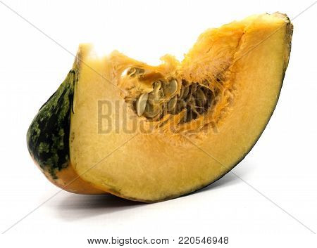 One spotty green yellow pumpkin slice with seeds isolated on white background