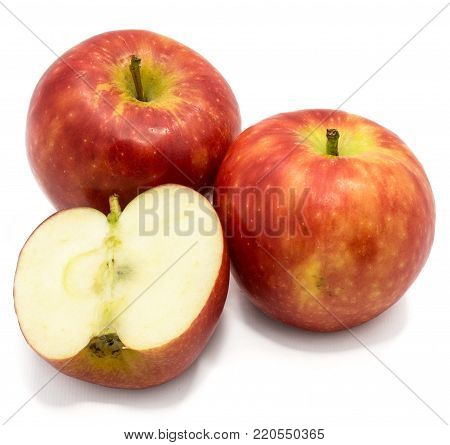 Red Kanzi apples, two whole, one half, isolated on white background