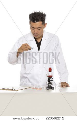Asian male medical student wearing a lab coat isolated on a white background.  The man is a heathcare worker or an intern.