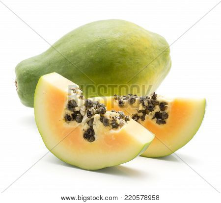 Green papaya (pawpaw, papaw) one whole and two slices with seeds isolated on white background