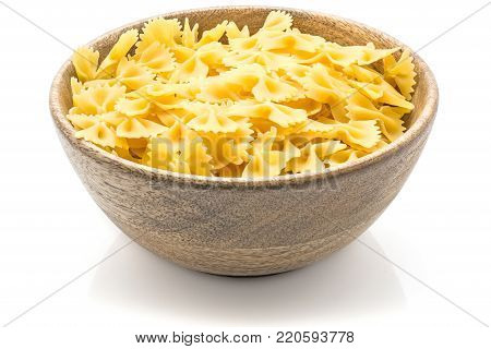 Raw farfalle in a wood bowl isolated on white background