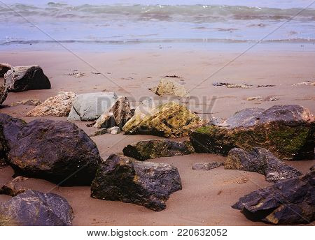 Landscape image of beautiful rock formation, on sandy beach
