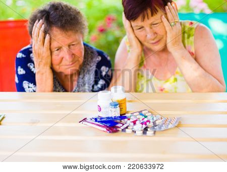 Sad sick women holding their head because of the cost medicine for illness.