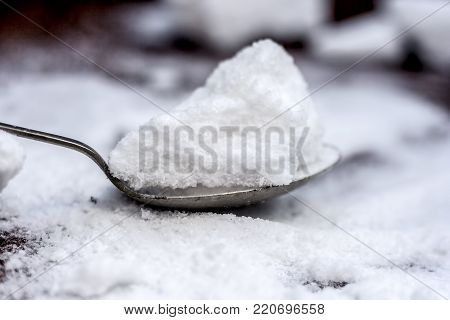 Common Salt,sodium Chloride In A Wooden Scoop On Wooden Floor.