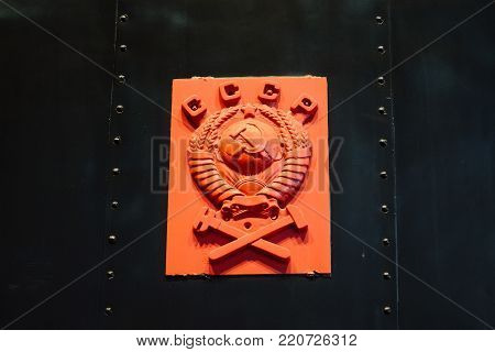 Golden soviet CCCP emblem with hammer and sickle on a marble plate. Russia. Saint-Petersburg. Museum Railways of Russia December 21, 2017.