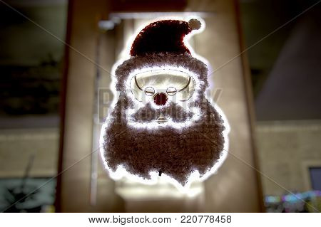 Photo of a happy Santa Claus with glasses made of light bulbs