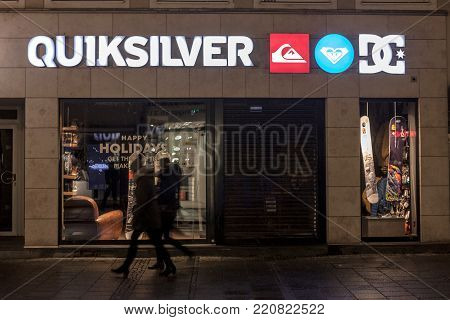 MUNICH, GERMANY - DECEMBER 17, 2017: Quiksliver logo on their Munich main shop taken at night. Quiksilver is an American retail sporting company